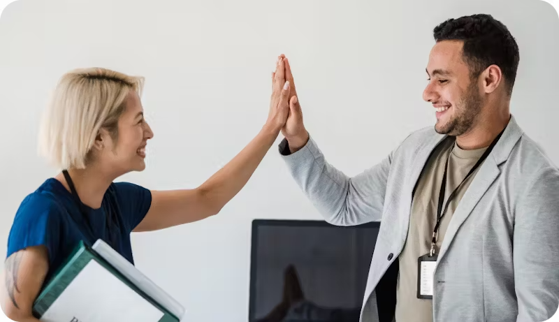Colleagues clapping hands after finding the right company insurance 