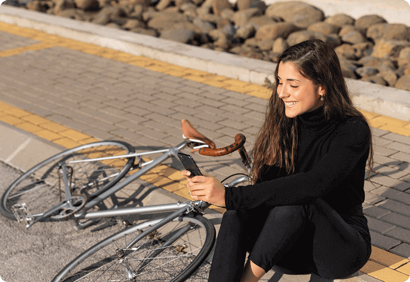 Woman sitting next to her road bike. 