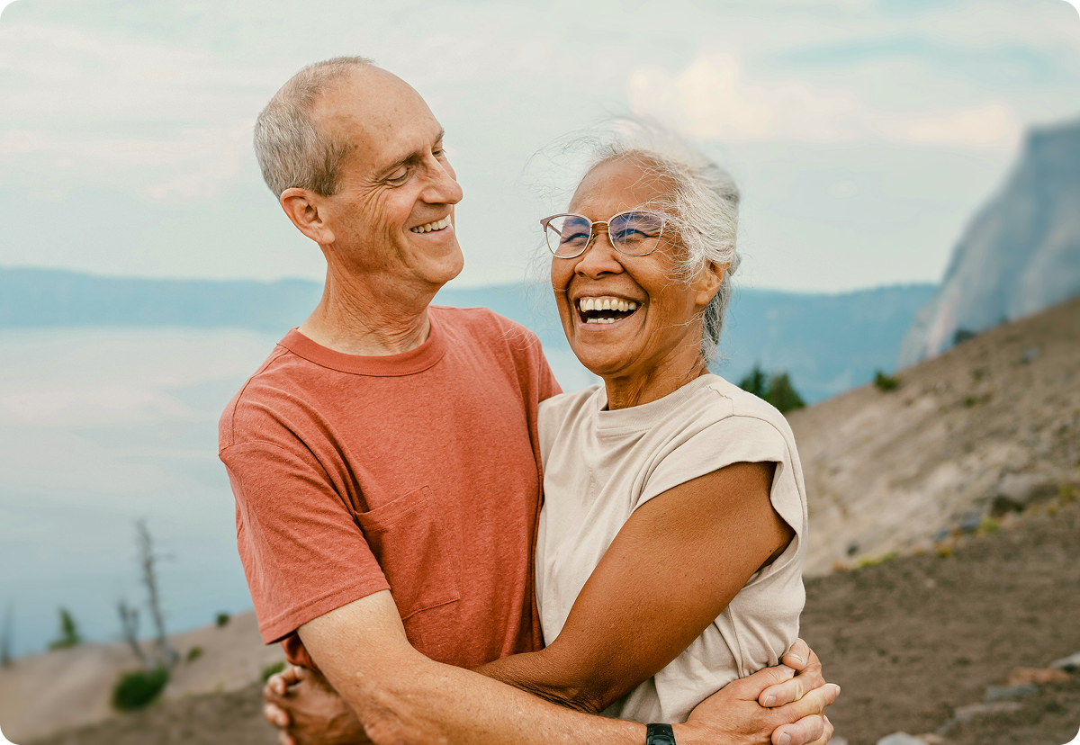 A retiree couple smiling outside
