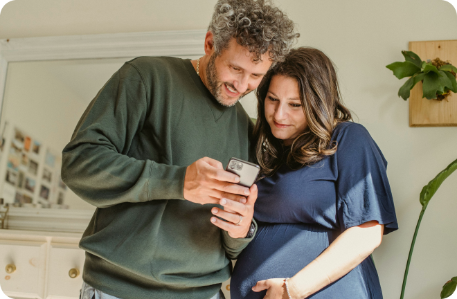 a young couple watching a phone