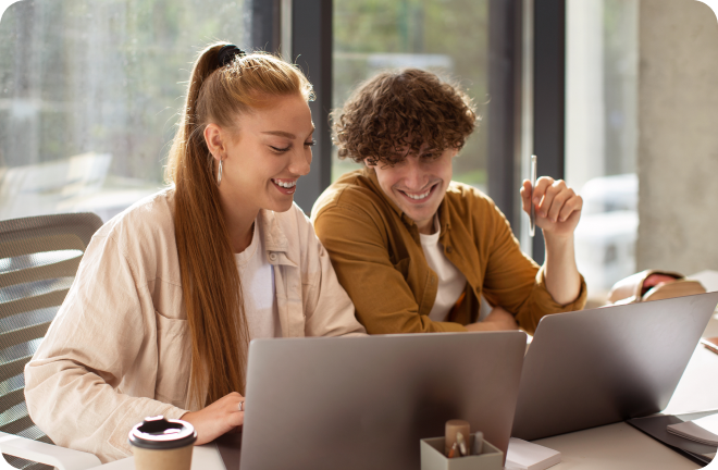 2 friends looking to their laptops