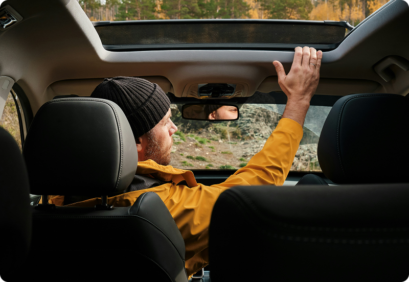 A man sitting in his parked car.