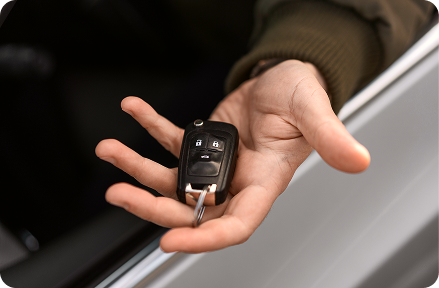 Person holding a car key of a car newly registered in Germany.