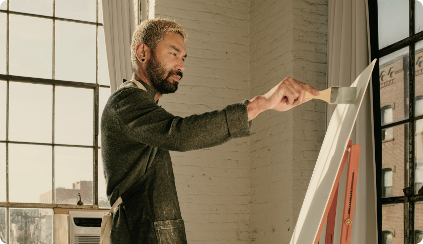 A freelance painter working on a new art piece in his studio.