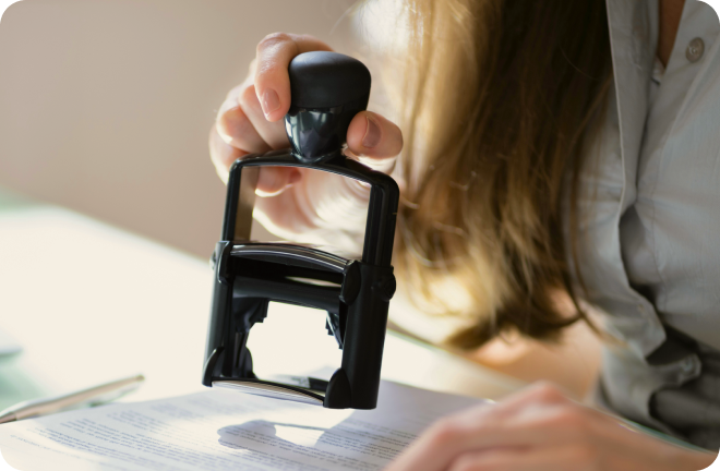 A public office representative approving documents with a stamp in Sweden.