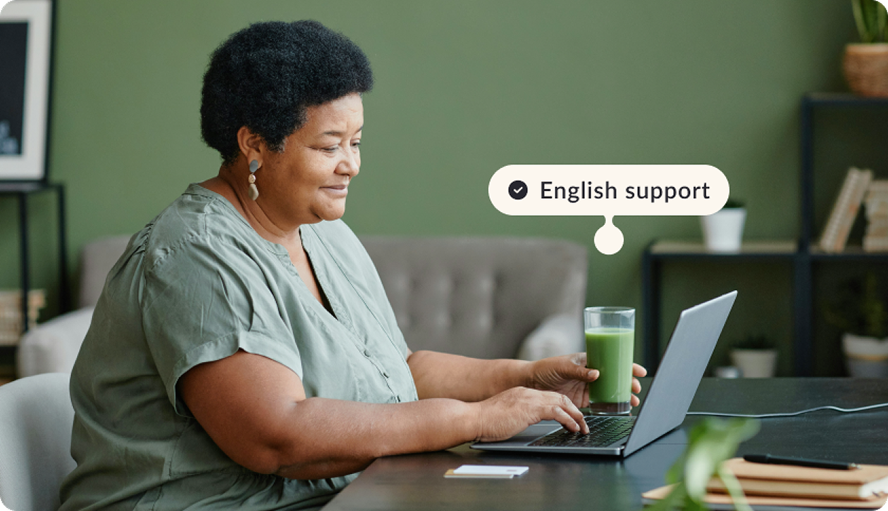 women sitting looking to a laptop