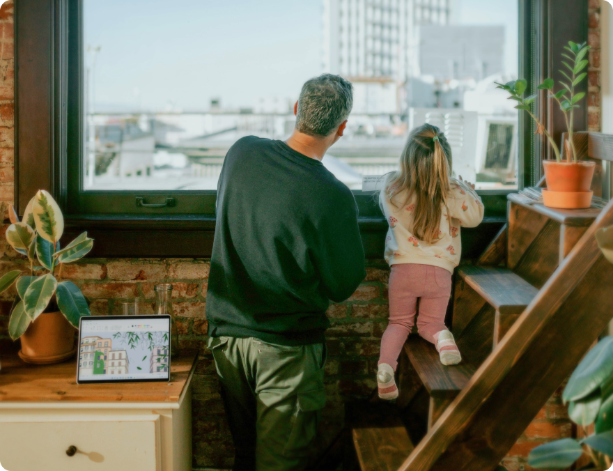 A father and his daughter looking through the window in their cozy apartment in Romania.