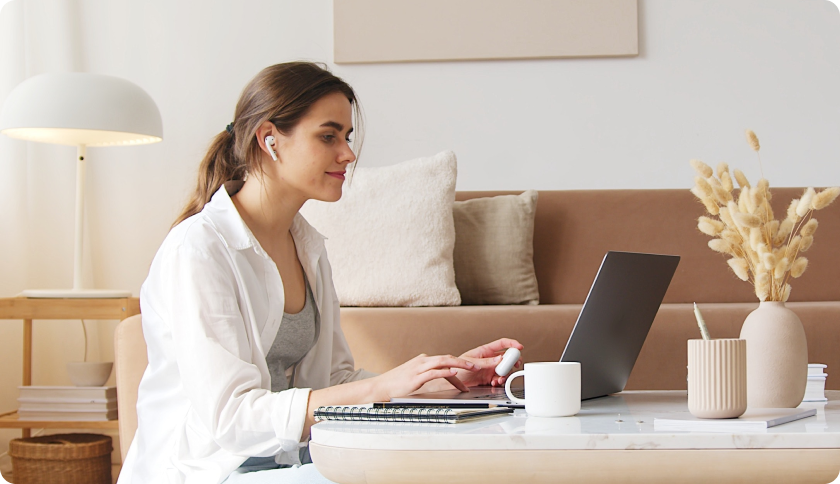 Woman looking at laptop.